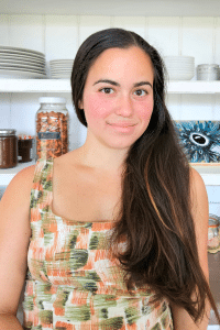 Women smiling at camera in front of a white buffet. Homemaking