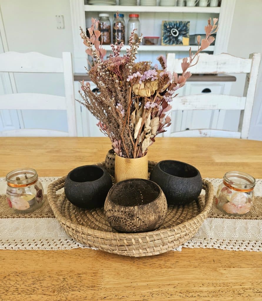 Dinging table centre piece. Dried flowers in the middle with candles on either side. Beautiful home on a budget.