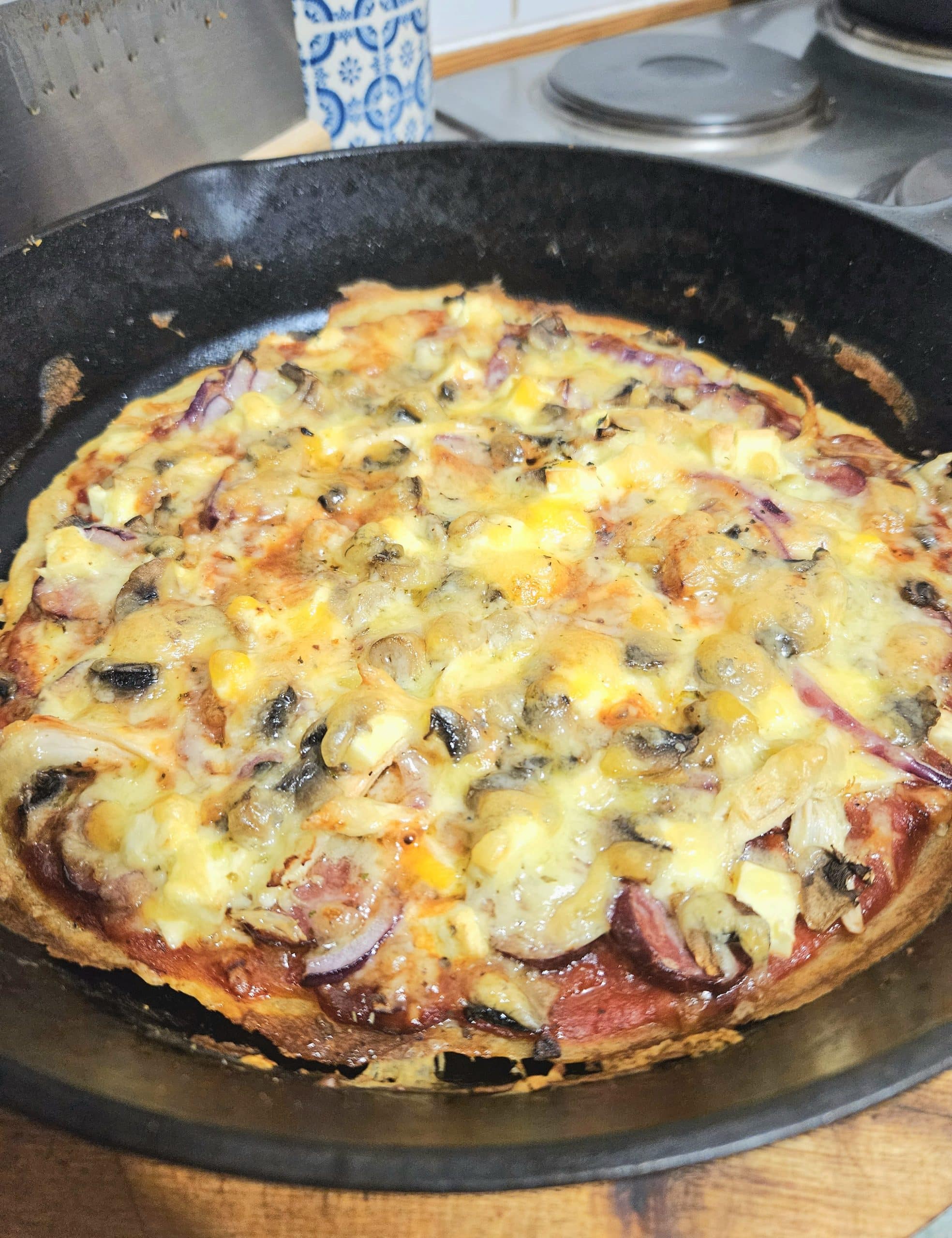 Sourdough discard pizza base topped with mushrooms, onion, pepperoni and cheese. Baked in the oven until nice and crispy.