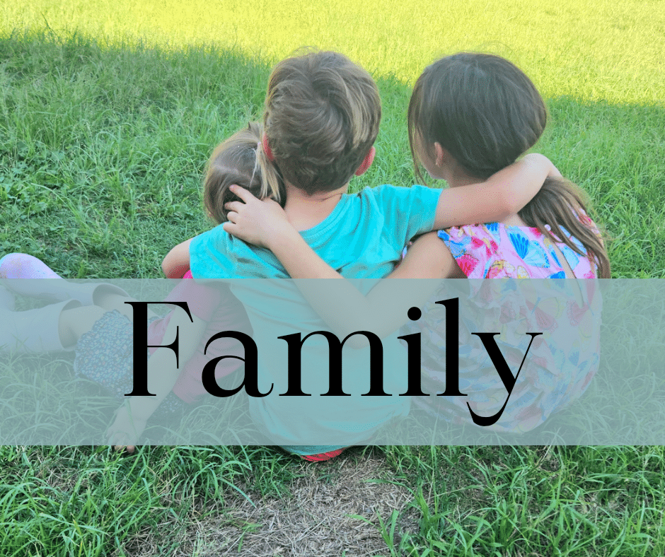 Kids hugging outside on the floor