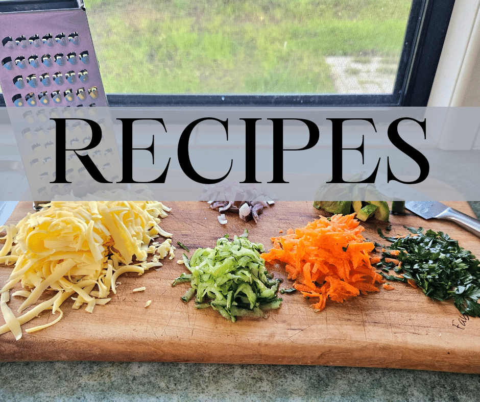 Chopped up food on a cutting board in kitchen counter.