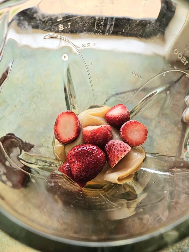 kombucha scoby mixed with water, honey and fruit in a blender.