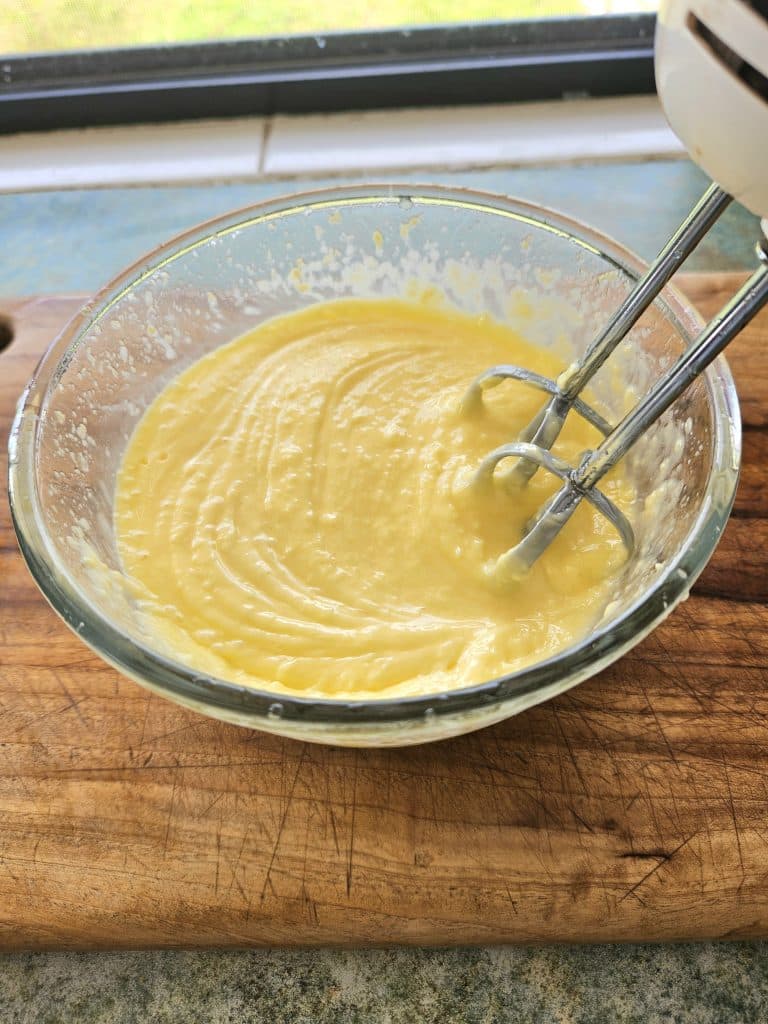 Hand blender mixing spreadable butter. 