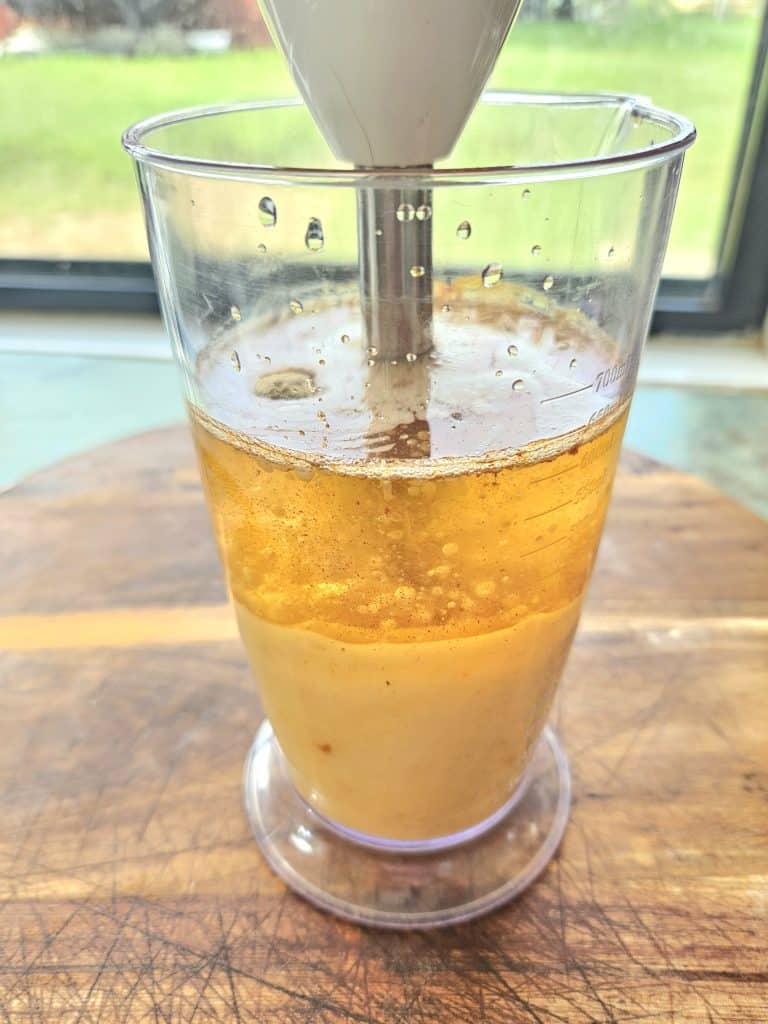 Making Mayonnaise. Using an immersion blender to blend eggs and oil.