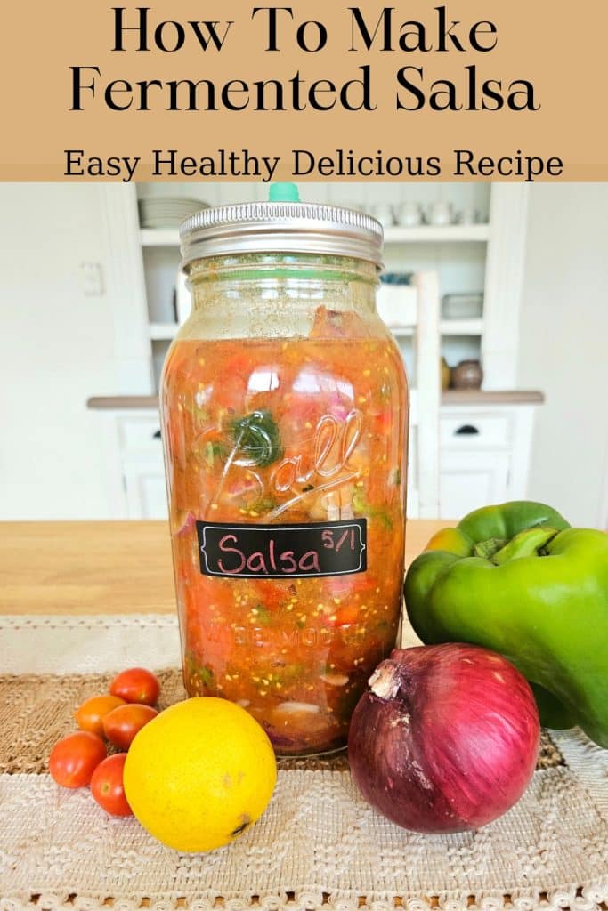 Fermented salsa on a dining table. Surrounded by capsicum, tomatoe, lemon and onion.