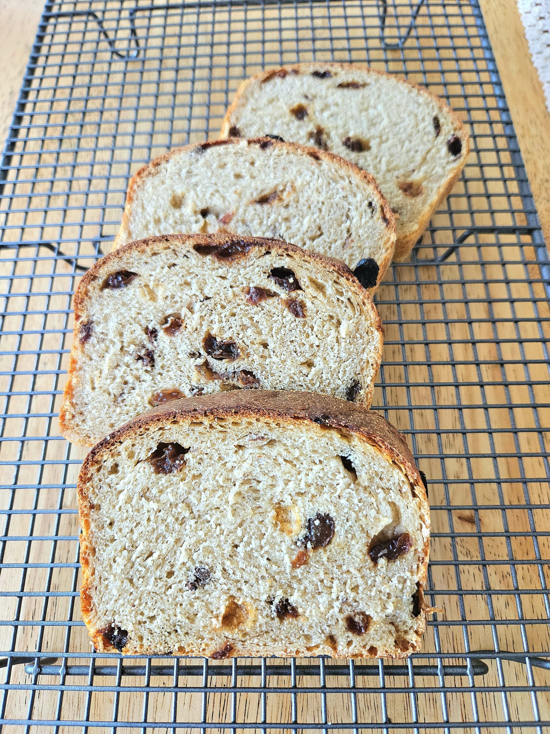 Sliced Sourdough Raisin bread on a cooling rack.