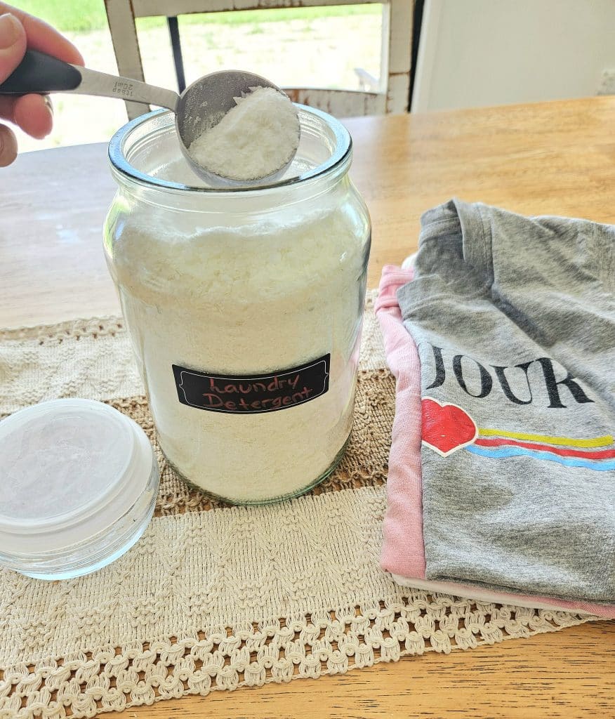 Homemade laundry detergent in a glass storage container.