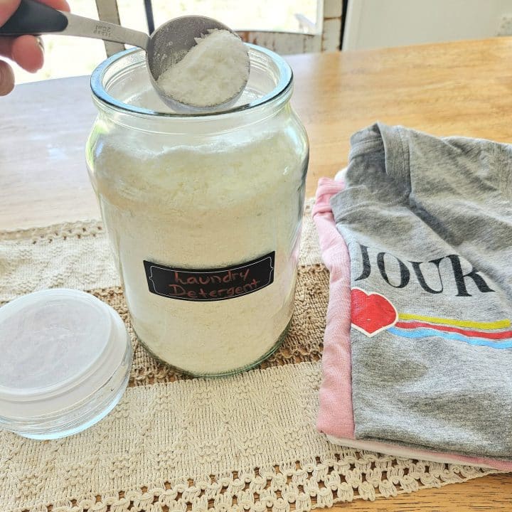 Homemade laundry detergent in a glass storage container.