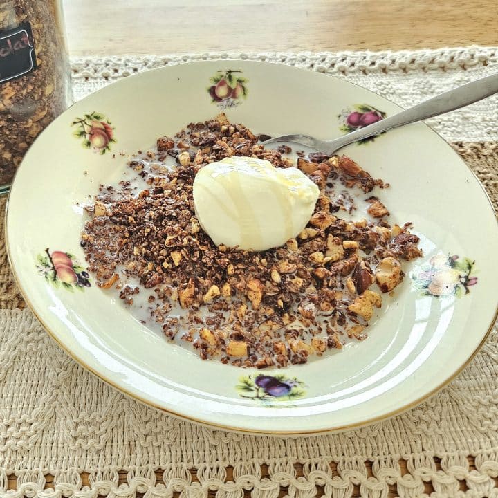 homemade granola recipe poured into a bowl served with milk and yoghurt.