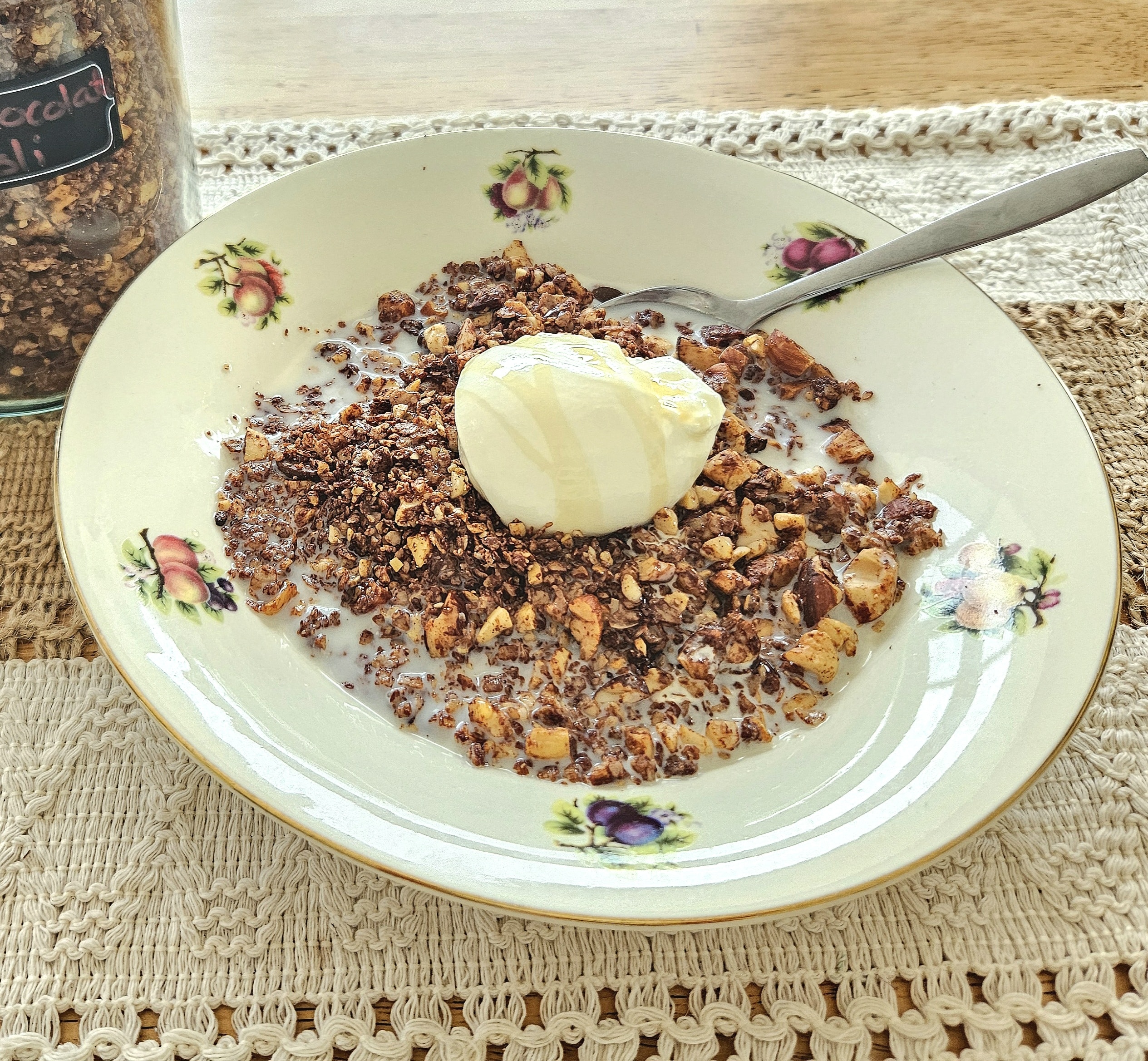 homemade granola recipe poured into a bowl served with milk and yoghurt.