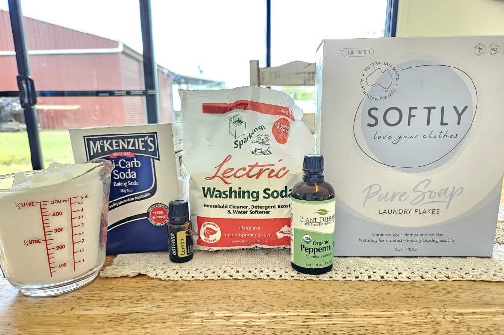 Ingredients for homemade natural laundry powder displayed on kitchen counter.