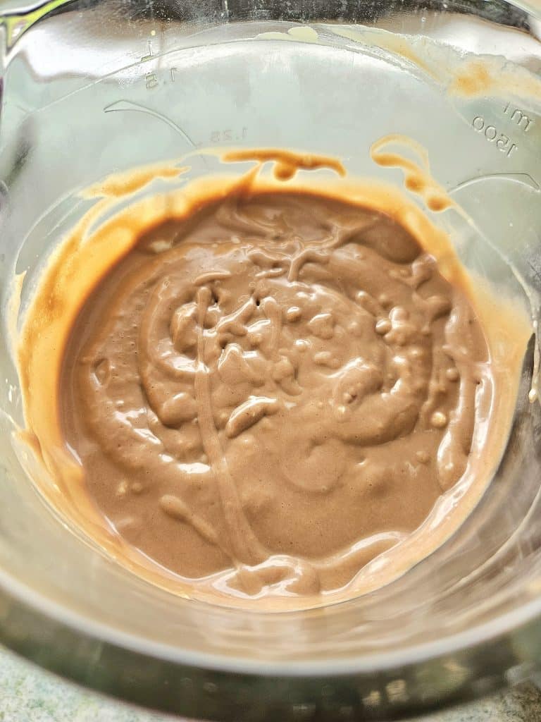 Creamy chocolate avocado smoothie in a blender.