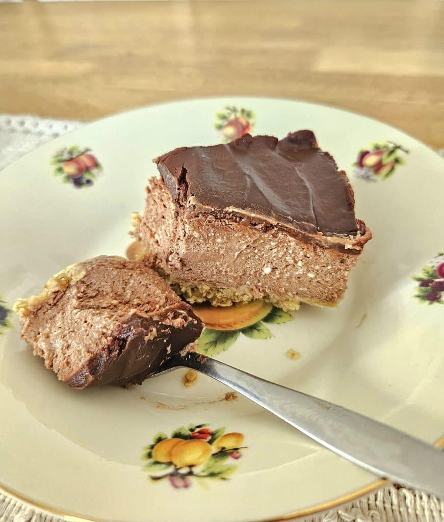 A slice of kefir chocolate cheesecake in a bowl on a table.