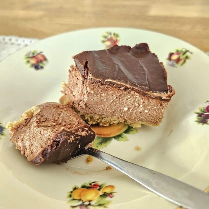 A slice of kefir chocolate cheesecake in a bowl on a table.