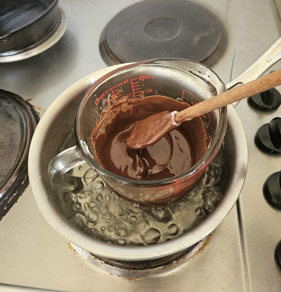 Melting chocolate for cheesecake.