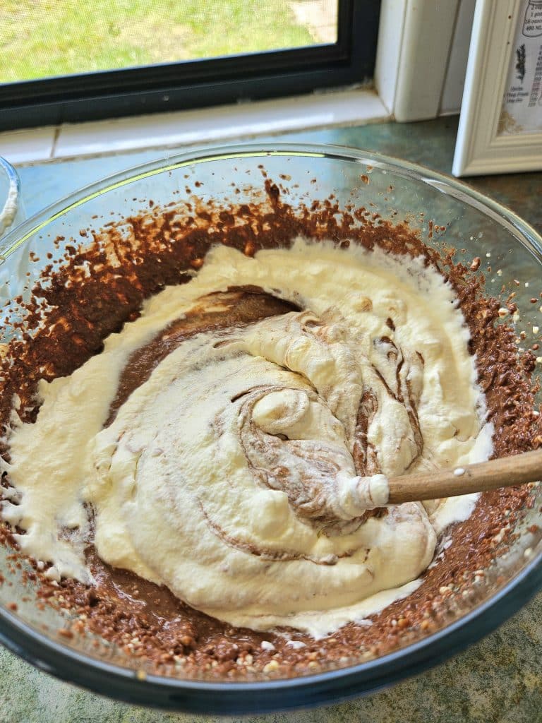 Mixing cream into kefir chocolate cheesecake