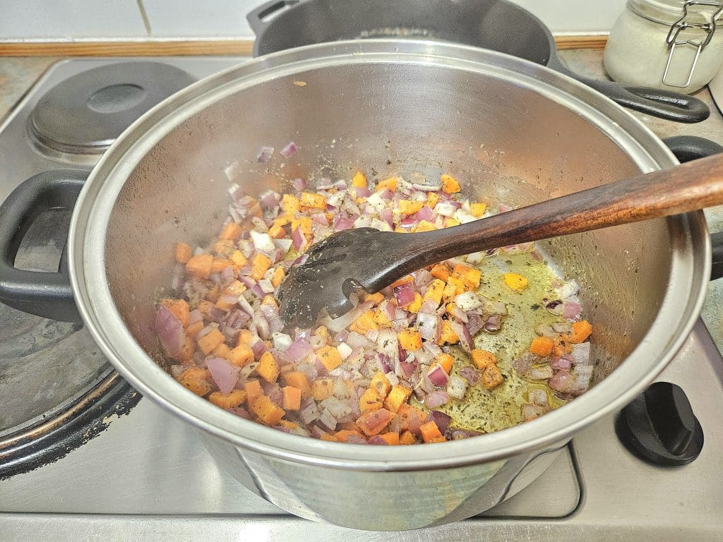 Chicken noodle soup cooking in a pot.