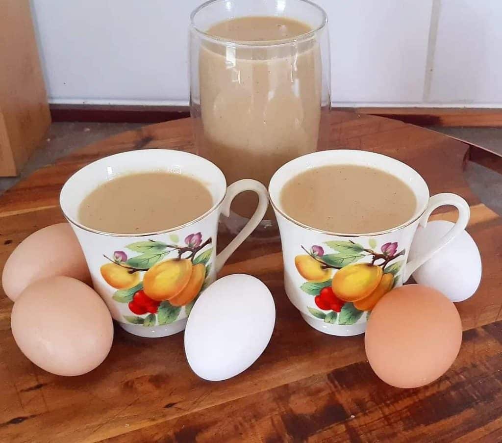 homemade eggnog poured into cups.