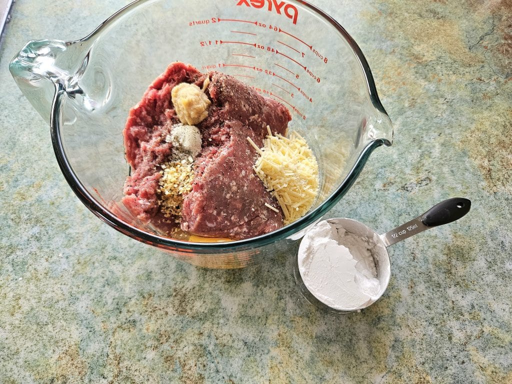 Meatball ingredients in a Pyrex container.