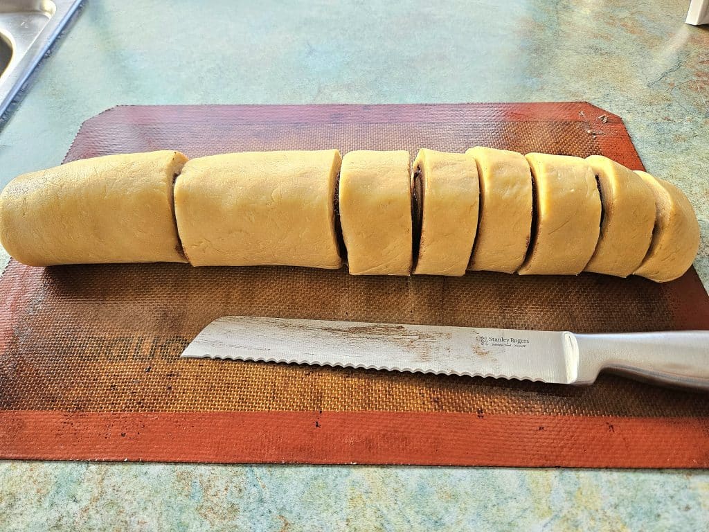 Slicing sourdough cinnamon rolls.