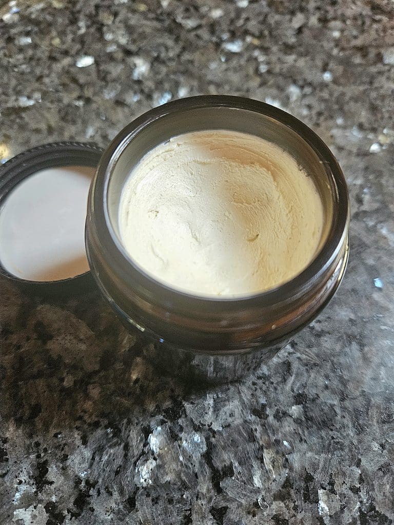 Homemade sunscreen in a jar on the counter.