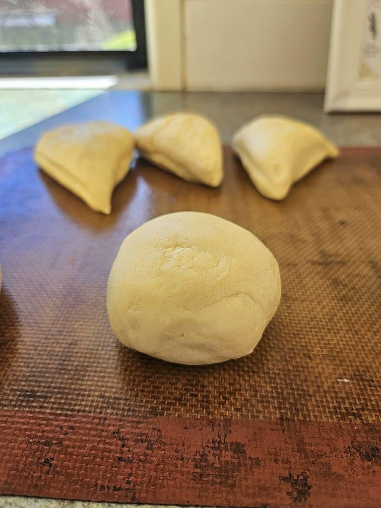 Sourdough hamburger buns resting.