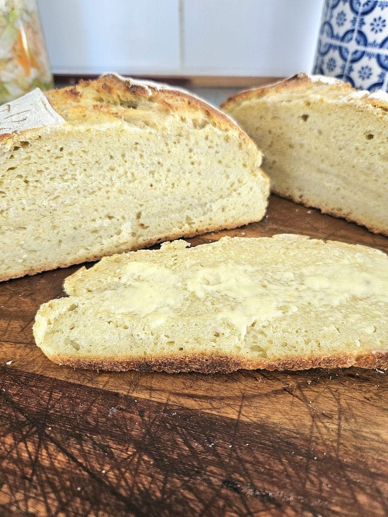 Sliced sourdough artisan bread on a cutting board.