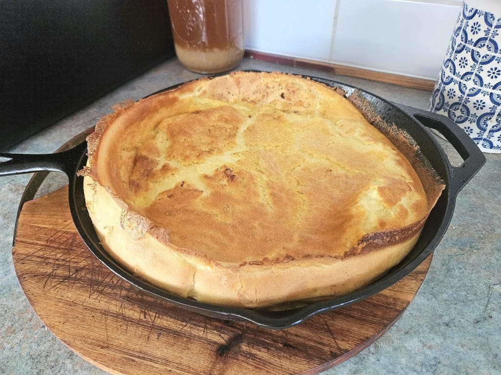 Finished Dutch pancake in a cast iron pan.