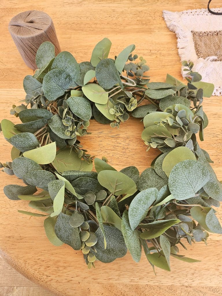 Adding foliage to homemade wreath.