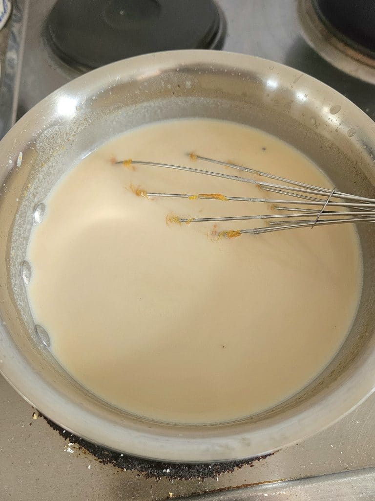 Melting White chocolate and milk in a pot.