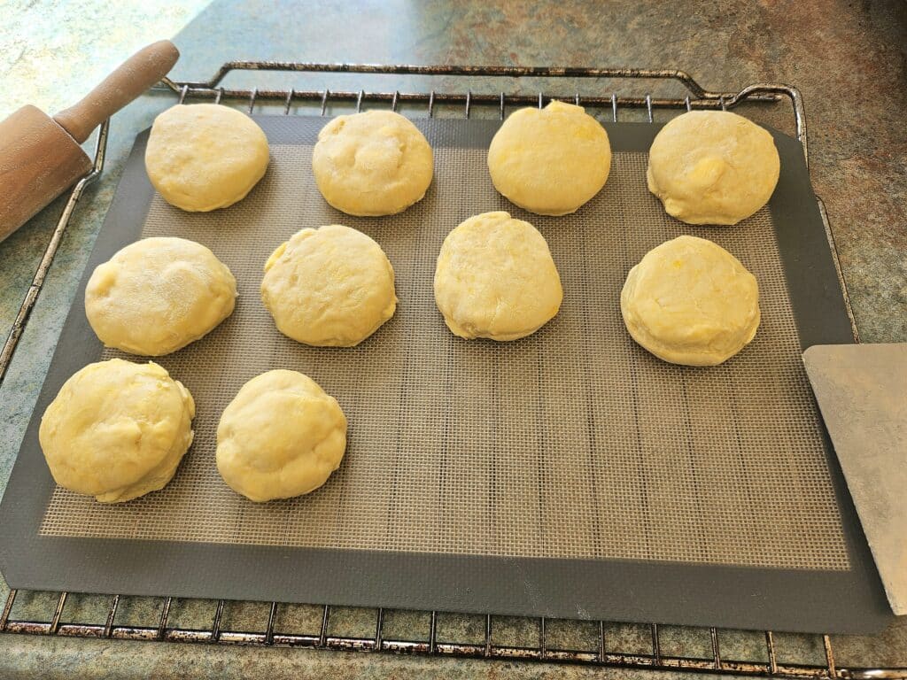 Sourdough discard scones resting on a silicon mat. 