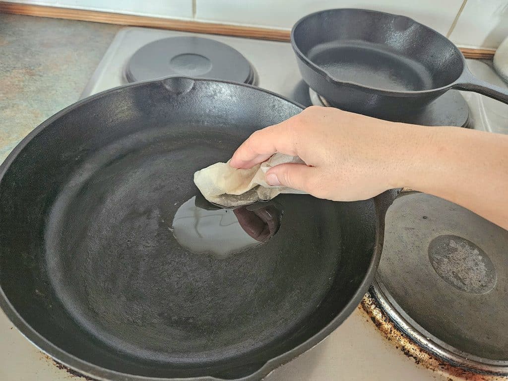 Oiling a cast iron pan on the stove.