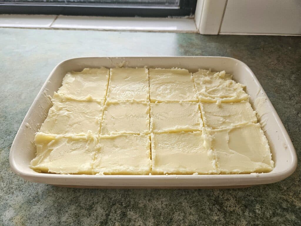 Beef tallow cooled in a pan and sliced.