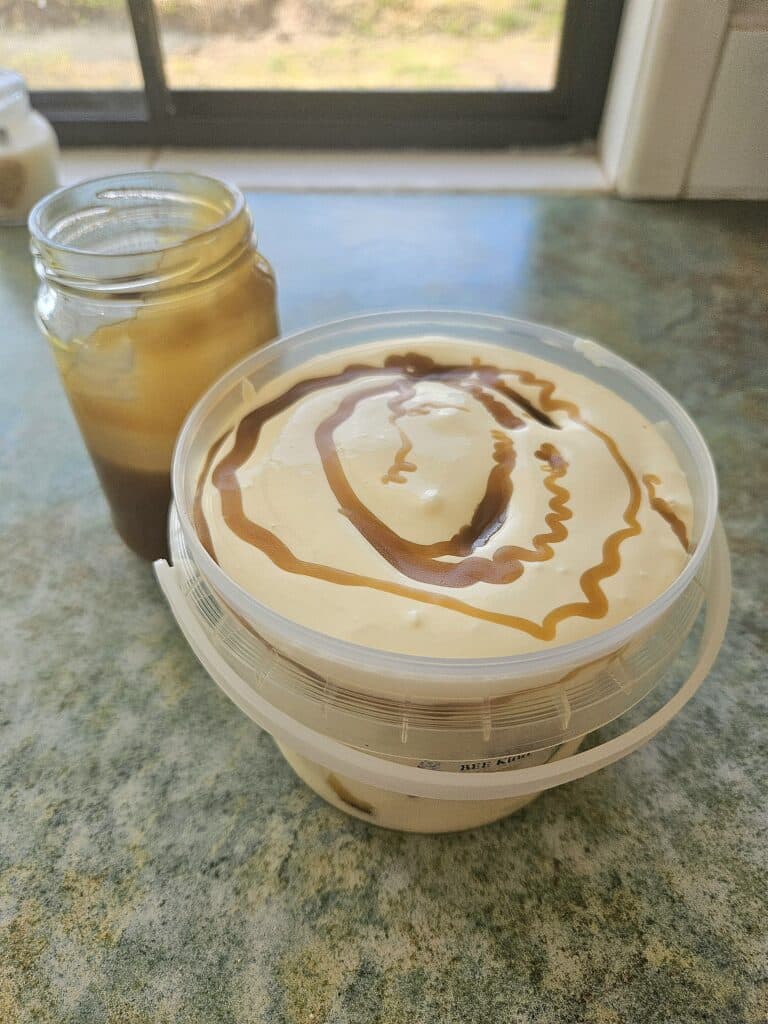 Adding flavours into homemade ice cream container.