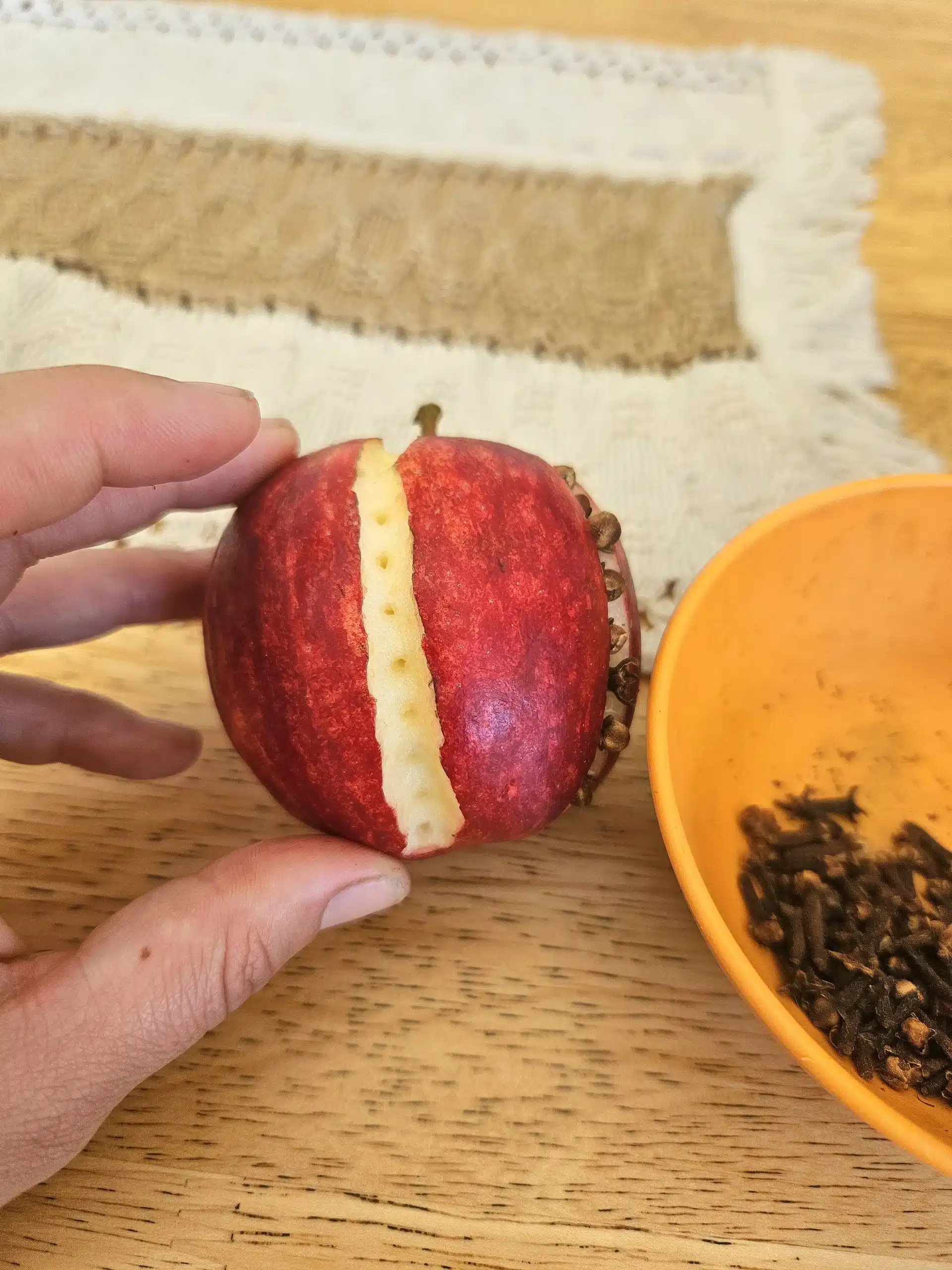 Making homemade apple pomanders.