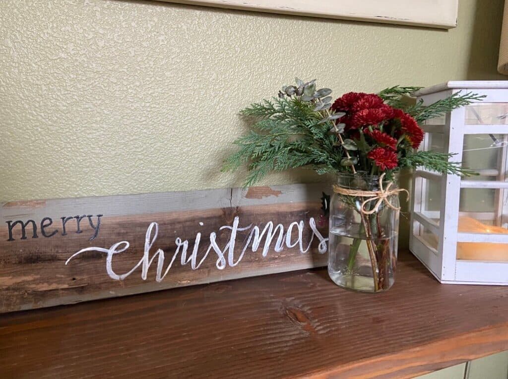 Making a Christmas floral arrangement on a table. 