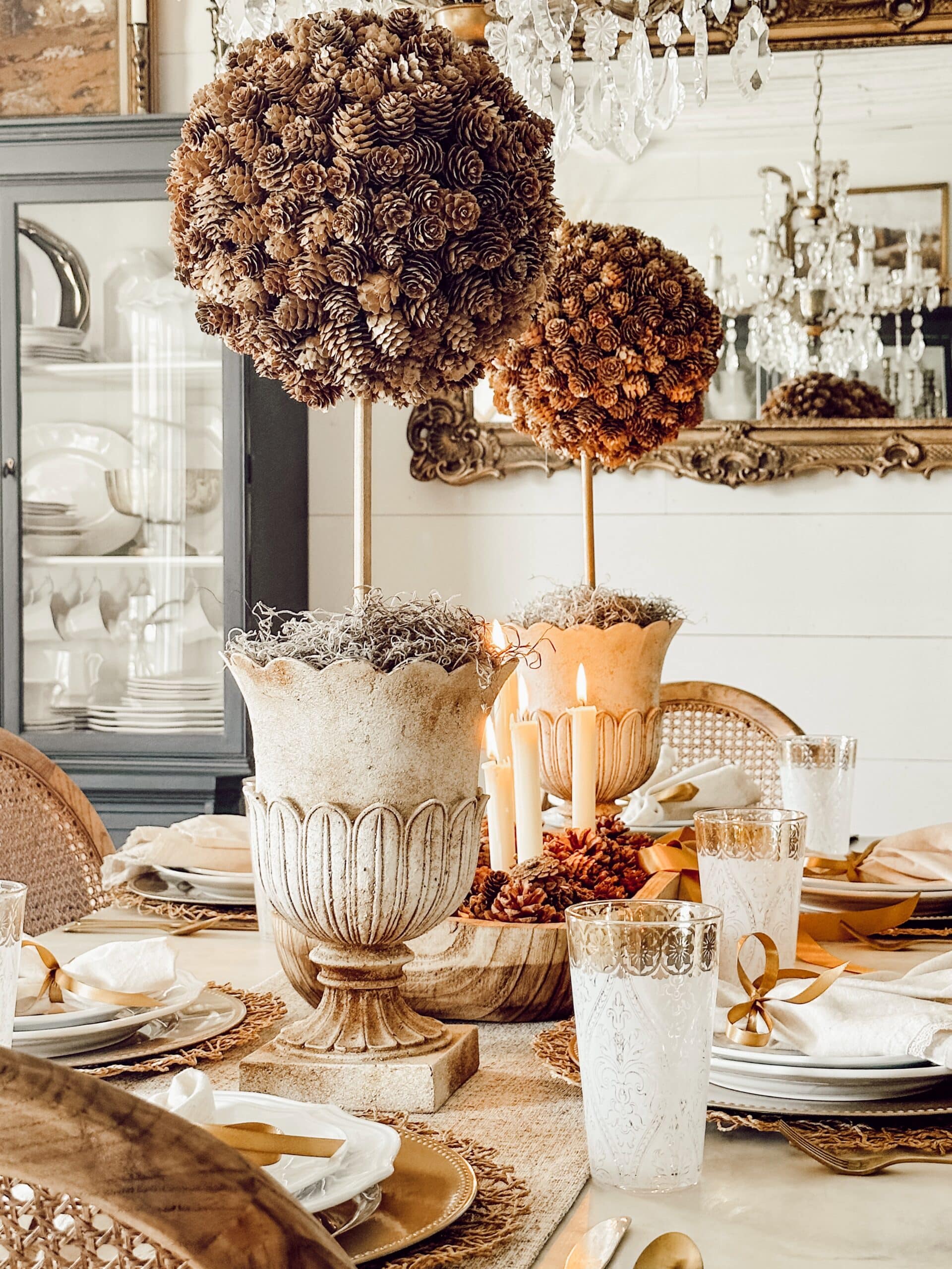 DIY fall craft pinecone topiary on a table.