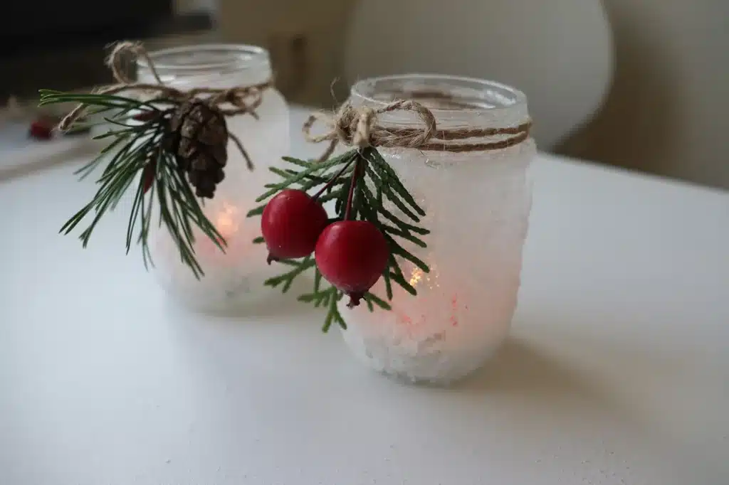 Frosted glass jars with Christas decorations.