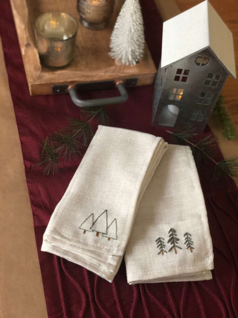 Hand embroidered Christmas napkins on the table.