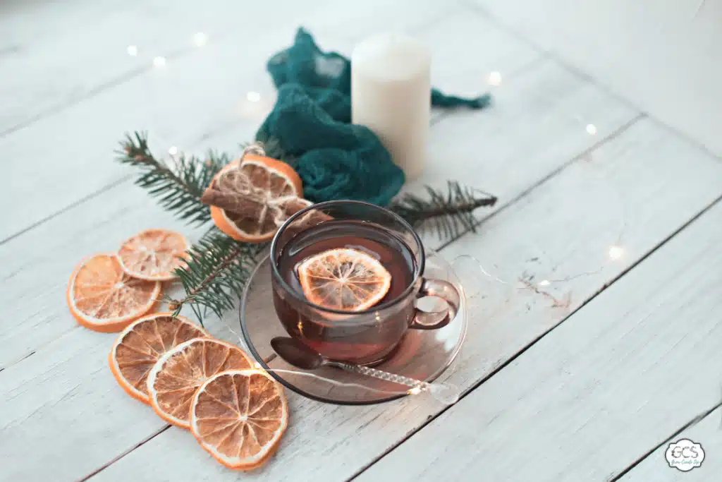 Dried oranges on a table and in a cup. Autumn decorations