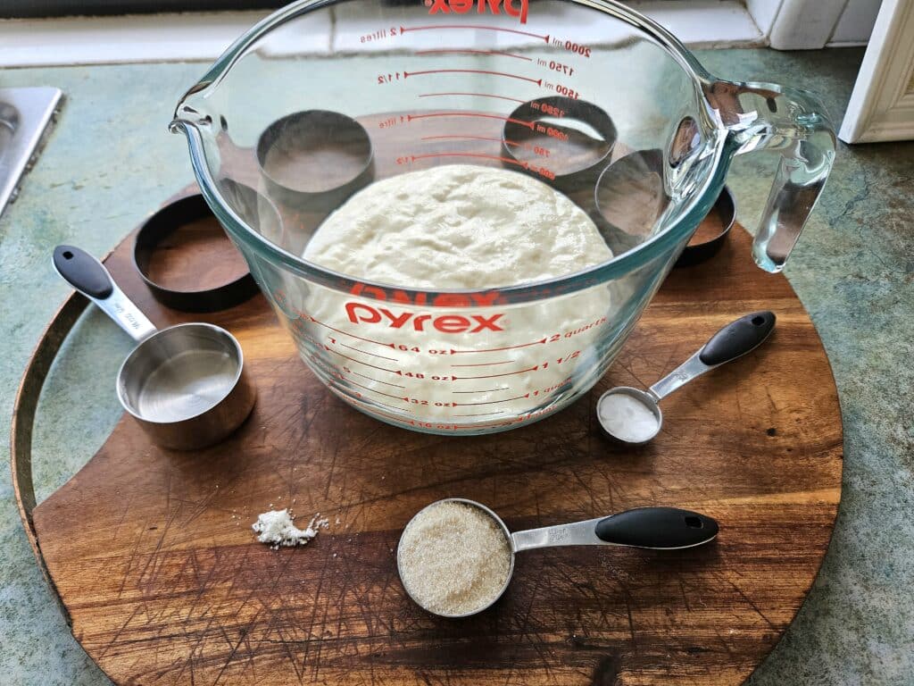 Sourdough crumpet ingredients displayed on a cutting board.