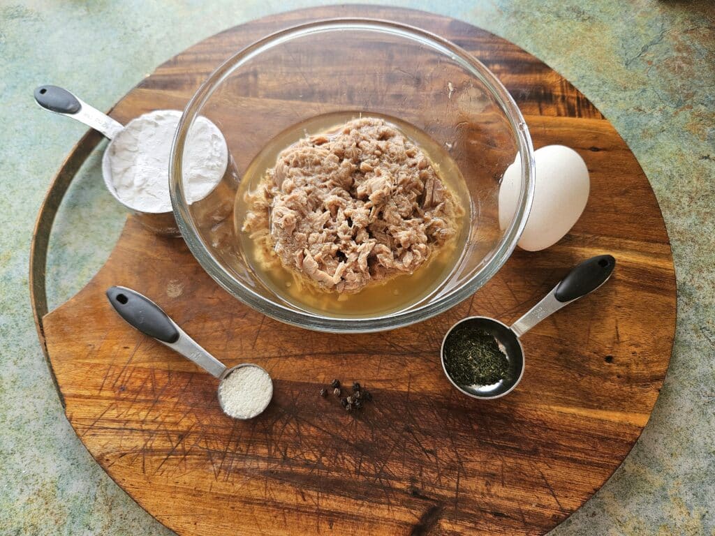 Tuna fritter ingredients on a cutting board.