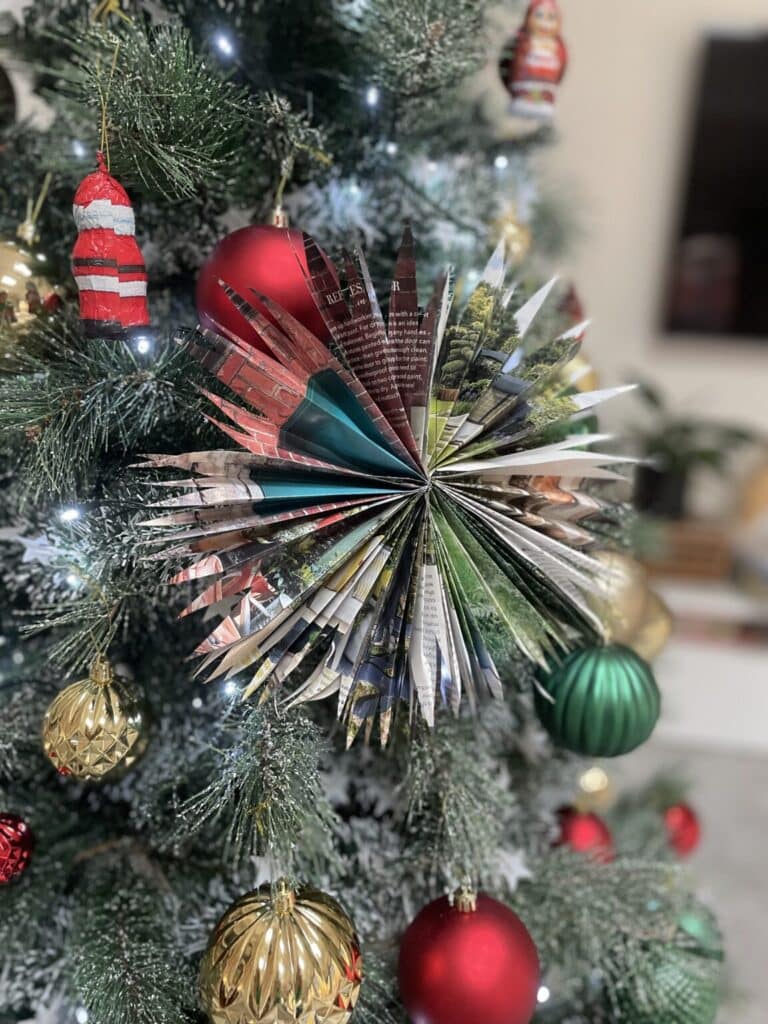 Paper star ornament on a tree.