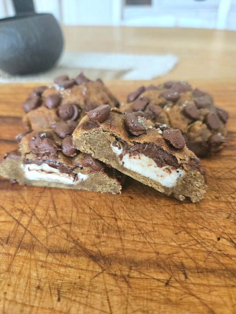 Smore cookie cut in half on a cutting board.