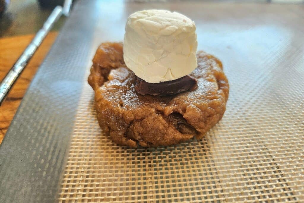 Chocolate bar and marshmallow on cookie dough.