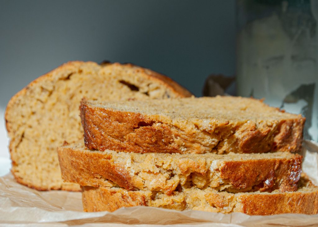 Soft homemade sourdough banana bread sliced on parchment paper.