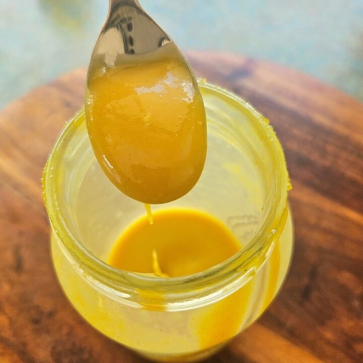 Creamy honey mustard on a spoon.