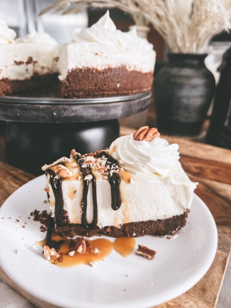 Homemade no bake cheesecake covered in chocolate and caramel.