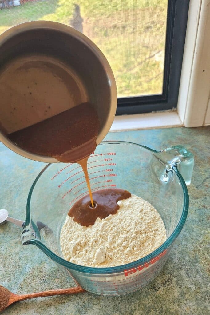 Pouring caramelized butter onto flour.