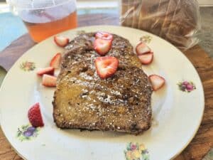 Sourdough French toast on a plate with strawberries.